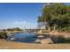 Serene community lake with fountain and rocks at 297 W Seaside Dr, Casa Grande, AZ 85122