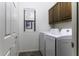 Laundry room with washer, dryer, and cabinets at 297 W Seaside Dr, Casa Grande, AZ 85122