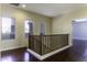 Upstairs hallway with hardwood floors and railing at 297 W Seaside Dr, Casa Grande, AZ 85122