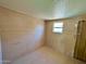 Small bedroom with window and wood paneling at 303 S Recker Rd # 175, Mesa, AZ 85206