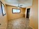 Bright bedroom with tile flooring, ceiling fan, and ample closet space at 303 S Recker Rd # 175, Mesa, AZ 85206