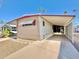 Mobile home with carport and landscaped yard at 303 S Recker Rd # 175, Mesa, AZ 85206