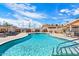 Inviting community pool with ample seating and palm trees at 303 S Recker Rd # 175, Mesa, AZ 85206