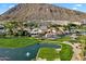 Aerial view of resort with pond, golf course, and mountain views at 5008 N Ascent Dr, Scottsdale, AZ 85251