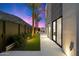 Landscaped backyard with grass, lighting, and modern finishes at 5008 N Ascent Dr, Scottsdale, AZ 85251