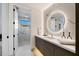 Modern bathroom with marble tile, large mirror, and walk-in shower at 5008 N Ascent Dr, Scottsdale, AZ 85251