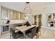 Modern dining room with a large table, wine storage, and contemporary lighting at 5008 N Ascent Dr, Scottsdale, AZ 85251