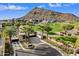 Gated entrance to community with palm trees and mountain views at 5008 N Ascent Dr, Scottsdale, AZ 85251
