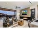 Spacious living room with fireplace, large TV and access to outdoor patio at 5008 N Ascent Dr, Scottsdale, AZ 85251