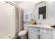 Bathroom with a white vanity, beige shower curtain, and a frameless shower at 5203 W Roundhouse Rd, Laveen, AZ 85339