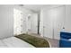 Bedroom with a bed, green throw, and white closet doors at 5203 W Roundhouse Rd, Laveen, AZ 85339