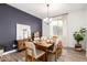 Elegant dining room with hardwood floors, a wooden dining table, and modern light fixture at 5203 W Roundhouse Rd, Laveen, AZ 85339