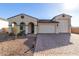 Two-story house with a three-car garage and landscaped front yard at 5203 W Roundhouse Rd, Laveen, AZ 85339