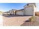 Two-story house with a large three-car garage and desert landscaping at 5203 W Roundhouse Rd, Laveen, AZ 85339