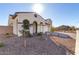 Two-story house with a three-car garage and desert landscaping at 5203 W Roundhouse Rd, Laveen, AZ 85339