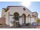 Tan two-story house with arched entryways and a three-car garage at 5203 W Roundhouse Rd, Laveen, AZ 85339