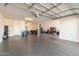 Spacious garage with ample storage shelving and overhead door at 5203 W Roundhouse Rd, Laveen, AZ 85339