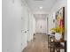 Bright hallway with wood-look tile flooring and entryway at 5203 W Roundhouse Rd, Laveen, AZ 85339