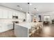 Modern kitchen with white cabinets, geometric backsplash, and large island with seating at 5203 W Roundhouse Rd, Laveen, AZ 85339