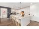 Modern kitchen with a large island, white cabinetry, and stainless steel appliances at 5203 W Roundhouse Rd, Laveen, AZ 85339