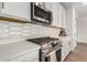 Modern kitchen features stainless steel appliances and white cabinets at 5203 W Roundhouse Rd, Laveen, AZ 85339
