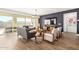 Bright living room features a large TV, comfortable seating, and sliding glass doors leading to the backyard at 5203 W Roundhouse Rd, Laveen, AZ 85339