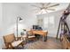 Home office with a desk, two chairs, and built-in shelving at 5203 W Roundhouse Rd, Laveen, AZ 85339