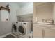 Laundry room with washer, dryer, and utility sink at 7251 E Portobello Ave, Mesa, AZ 85212