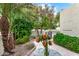 Landscaped patio with a table and sunflowers near the house at 7941 E Medlock Dr, Scottsdale, AZ 85250