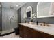Modern bathroom with double vanity, frameless shower and gold fixtures at 8701 E Highland Ave, Scottsdale, AZ 85251
