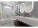 Elegant bathroom with double vanity, marble tile, and modern fixtures at 8701 E Highland Ave, Scottsdale, AZ 85251