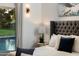 Main bedroom detail with nightstand and a view of the pool at 8701 E Highland Ave, Scottsdale, AZ 85251