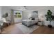 Bright bedroom with hardwood floors, large window, and stylish decor at 8701 E Highland Ave, Scottsdale, AZ 85251