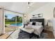 Main bedroom with plush bed, sliding doors leading to a pool view at 8701 E Highland Ave, Scottsdale, AZ 85251