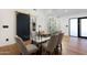 Elegant dining room with glass table and modern barn door at 8701 E Highland Ave, Scottsdale, AZ 85251