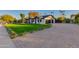 Contemporary home with a spacious lawn, paver driveway, and modern garage at 8701 E Highland Ave, Scottsdale, AZ 85251