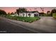 Modern home with a large grassy yard, paver driveway and walkway at 8701 E Highland Ave, Scottsdale, AZ 85251