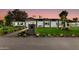 Stunning curb appeal featuring a remodeled mid-century modern home with a well-manicured lawn at 8701 E Highland Ave, Scottsdale, AZ 85251