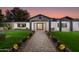 Elegant front entry with a brick walkway, landscaping, and modern lighting at 8701 E Highland Ave, Scottsdale, AZ 85251