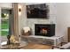 Modern fireplace with a contemporary tv and white brick surround at 8701 E Highland Ave, Scottsdale, AZ 85251