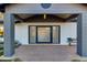 Modern front entrance with glass door, brick columns, and a welcoming porch at 8701 E Highland Ave, Scottsdale, AZ 85251