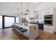 Modern kitchen with large island, white cabinets, and double ovens at 8701 E Highland Ave, Scottsdale, AZ 85251