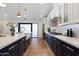 Modern kitchen with white and dark blue cabinets, quartz countertops and gold accents at 8701 E Highland Ave, Scottsdale, AZ 85251