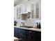 Modern kitchen with white cabinets, patterned backsplash and gas cooktop at 8701 E Highland Ave, Scottsdale, AZ 85251