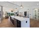 Open concept kitchen with island, wine storage and a view to the backyard at 8701 E Highland Ave, Scottsdale, AZ 85251