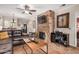 Living room features a stone fireplace and dark leather furniture at 9450 E Becker Ln # 1094, Scottsdale, AZ 85260
