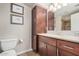 Bathroom boasts a granite vanity, dark wood cabinets, and tile flooring at 9450 E Becker Ln # 1094, Scottsdale, AZ 85260