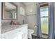 Bathroom with granite countertop, white cabinets, and a large window at 9913 W Pleasant Valley Rd, Sun City, AZ 85351