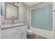 Bathroom with granite countertop, white vanity, and patterned shower curtain at 9913 W Pleasant Valley Rd, Sun City, AZ 85351