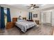 Bright bedroom with wood-look floors and ceiling fan at 9913 W Pleasant Valley Rd, Sun City, AZ 85351
